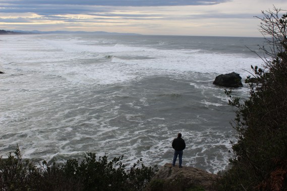Lee standing on rocks on right side