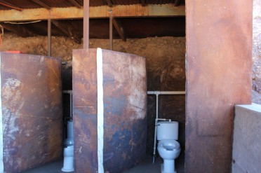 The wall behind the stalls was packed dirt which was cooler than the picture suggests. The dorrs are heavy iron. 