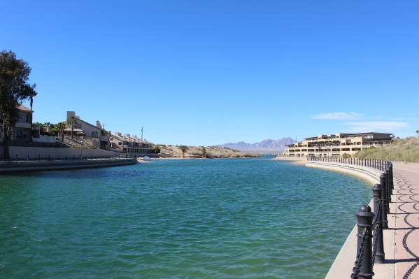 They built a man made canal which created an island the bridge could go to and the island has a golf course and upscale homes