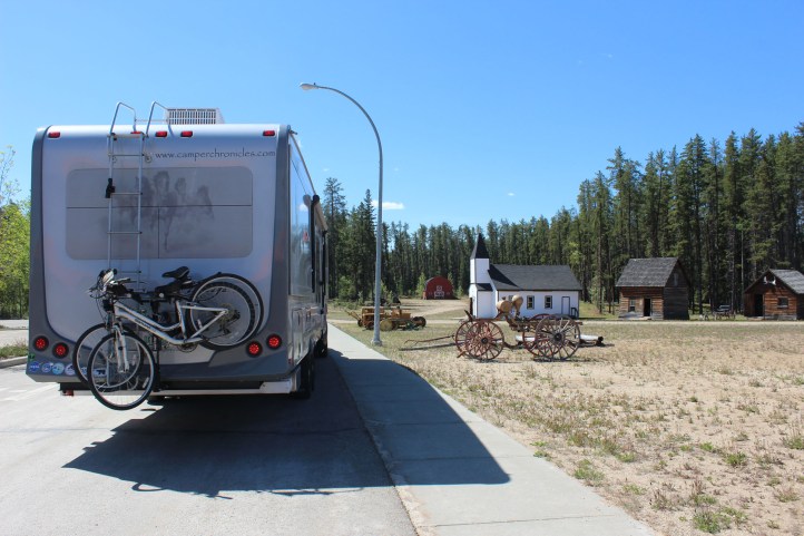 Parked right next to a few pioneer buildings