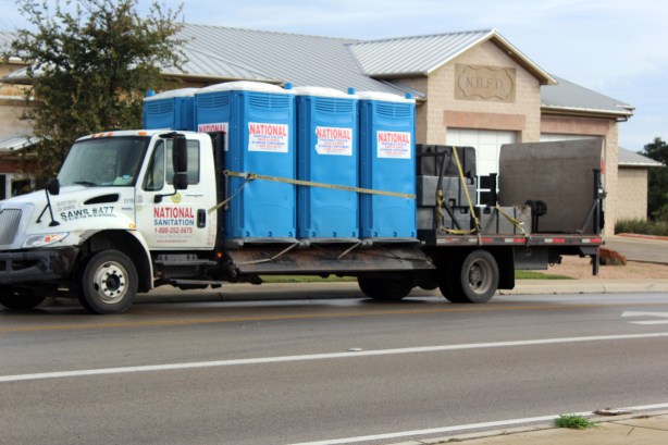 Delivery of our tank and port=a=potty. You can see the fire station behind us in the pic
